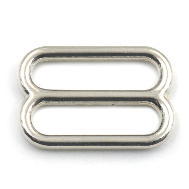 May include: Silver metal slider buckle with two oval loops.