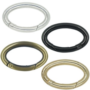 May include: Four oval-shaped metal swivel clasps in silver, black, gold, and antique brass.