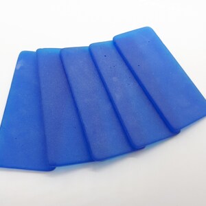 May include: Five blue rectangular silicone ice cube trays. The trays are stacked on top of each other.