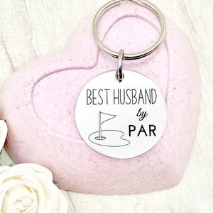 May include: Silver keychain with a round tag that says "BEST HUSBAND by PAR" with a golf flag and hole graphic.