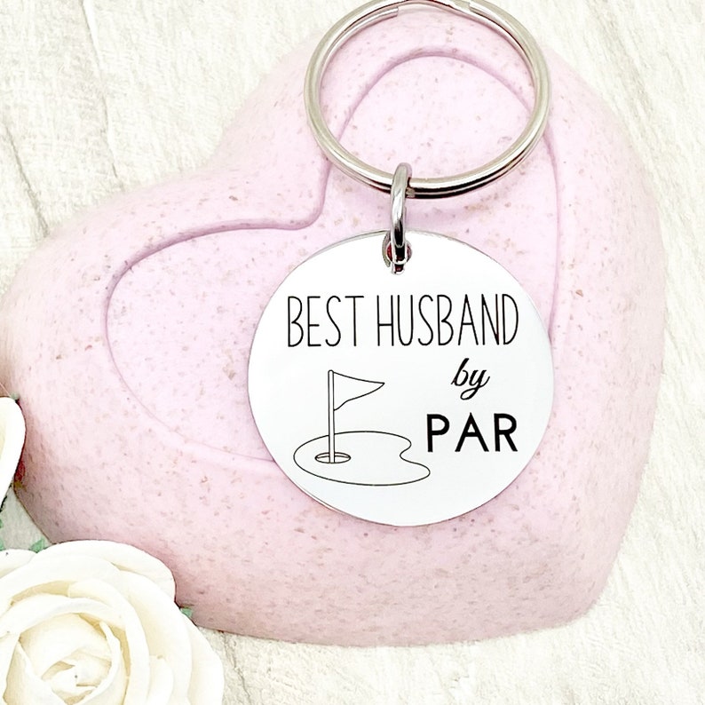 May include: Silver keychain with a round tag that says "BEST HUSBAND by PAR" with a golf flag and hole graphic.