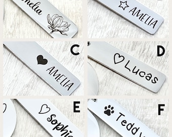 May include: Six silver metal keychains with different designs. The keychains feature the names Amelia, Lucas, Sophia, and Teddy, along with a star, heart, and paw print.
