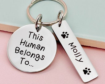 May include: Silver keychain with two tags. One tag says "This Human Belongs To..." and the other tag says "Molly" with a paw print.