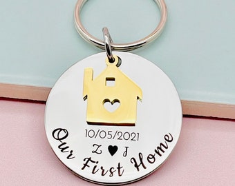 May include: Silver keychain with a gold house cutout and the text "Our First Home" with the date "10/05/2021" and the initials "Z ♥ J".
