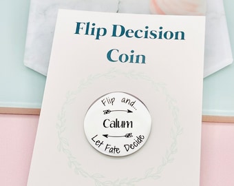 May include: A silver coin with the words "Flip and... Calum Let Fate Decide" engraved on it. The coin is on a white card with the text "Flip Decision Coin" and "Let fate decide... @makeitpersonalengraving".