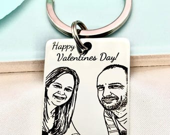 May include: A rectangular keychain with a silver ring features a black and white sketch of a couple and the text "Happy Valentines Day!". The keychain is a personalized gift, perfect for celebrating love and relationships.