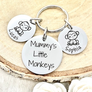 May include: Silver keychain with three round tags. The center tag reads "Mummy's Little Monkeys". The other two tags feature a monkey illustration and the names "Lucas" and "Sophia".