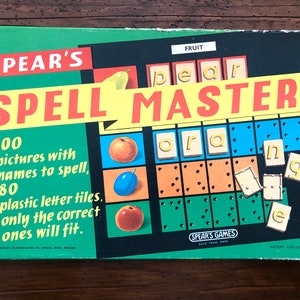 May include: A green and black board game box with the title "SPEAR'S SPELL MASTER". The box features illustrations of fruit, including a pear, an orange, and a plum. The game includes 100 pictures with names to spell and 80 plastic letter tiles.