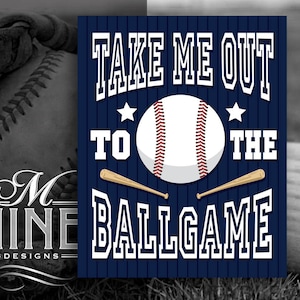 May include: A blue and white baseball themed sign with the text "Take Me Out To The Ballgame" and a baseball graphic. The sign has a white star on each side of the baseball.