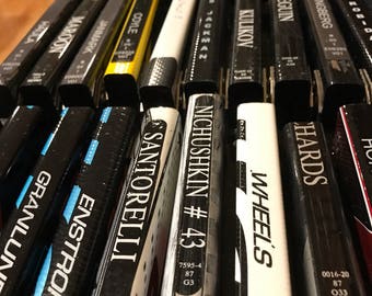 Game used hockey stick bottle opener (Pro Player names)