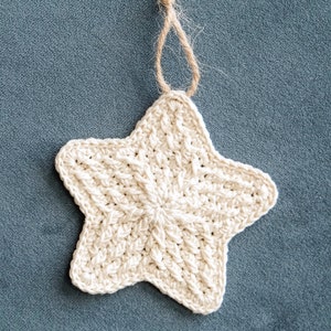 May include: A crocheted white star ornament with a brown twine loop for hanging.