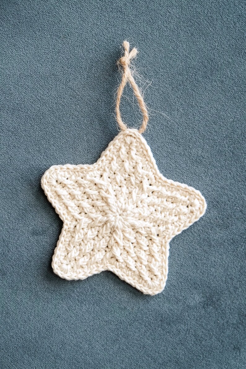 May include: A crocheted white star ornament with a brown twine loop for hanging.
