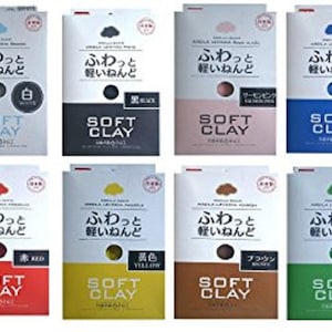 May include: Eight packages of Soft Clay in various colors, including white, black, salmon pink, blue, red, yellow, brown, and green. Each package has Japanese text and the words "SOFT CLAY".