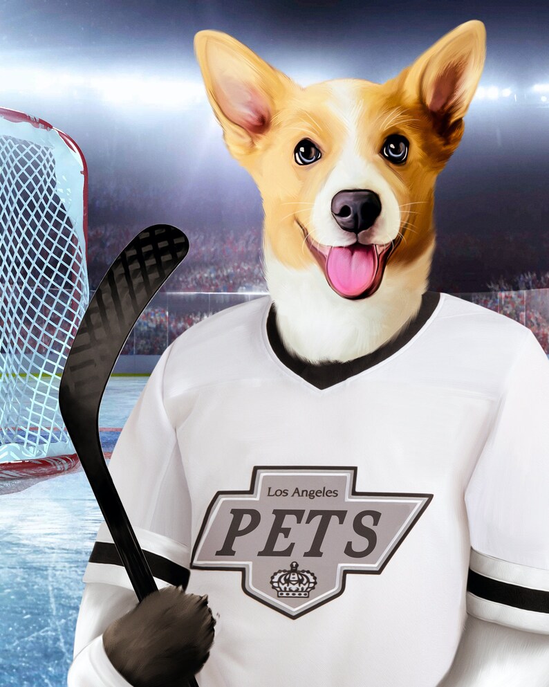 May include: A white hockey jersey with black and grey trim. The jersey has a grey patch with the text "Los Angeles PETS" and a crown logo. A dog wearing the jersey is holding a black hockey stick.
