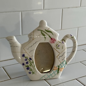 Hand-painted ceramic teapot picture frame with flower and bug design