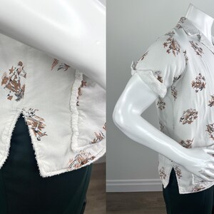 May include: White short-sleeve shirt with a brown and tan print. The shirt has a camp collar and is buttoned down the front. The sleeves are cuffed. The shirt is displayed on a mannequin.