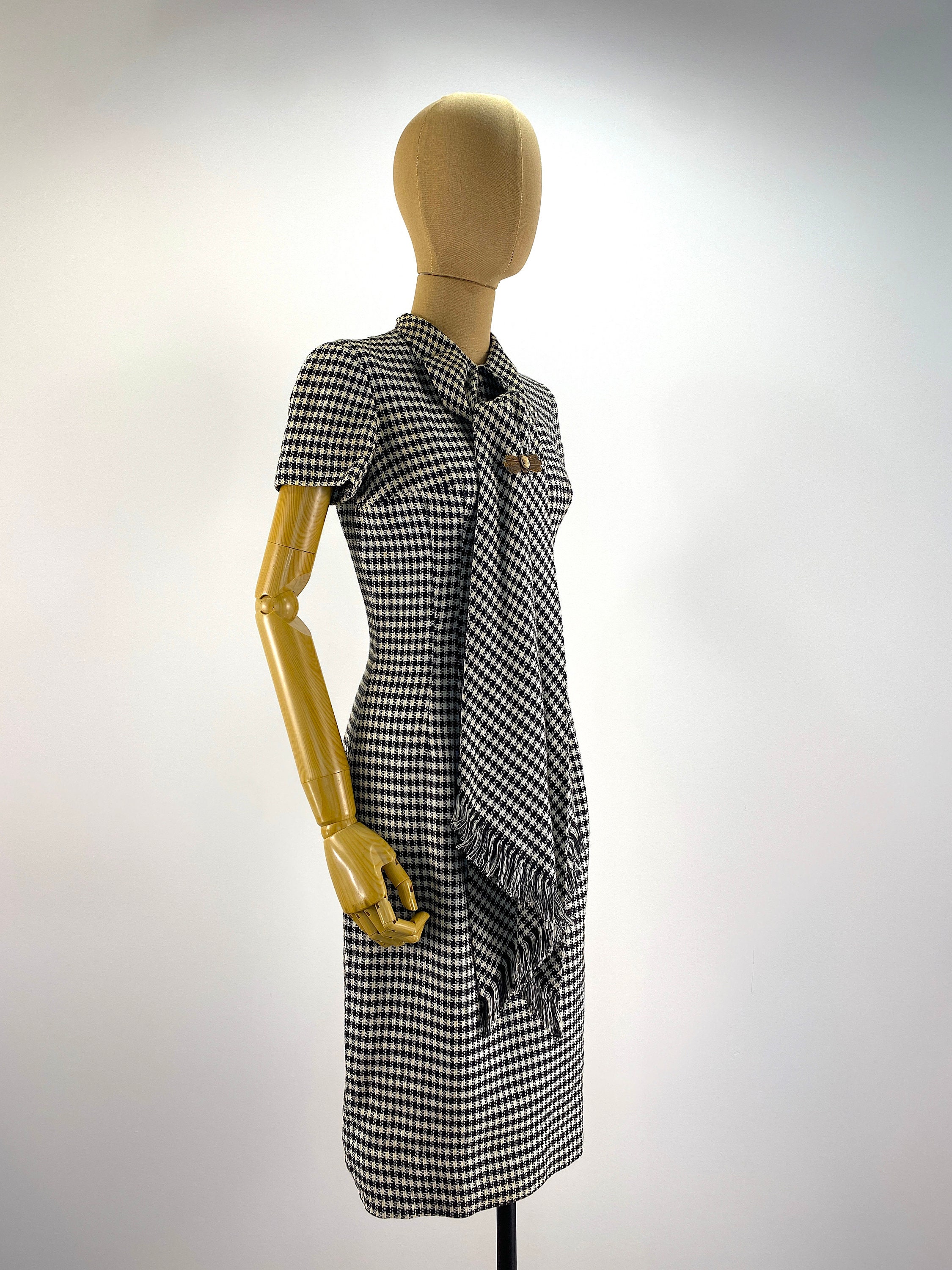 black dress caption NEW ON THE BLOCK HOUNDSTOOTH MINI DRESS  AKIRA