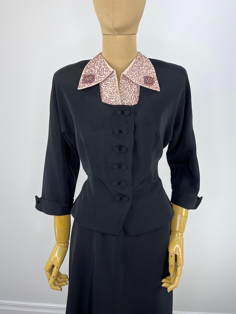 Authentic Vintage Formal Wear Late Forties Early Fifties Black Faille Suit Beaded Collar Jacket Nipped Waist Two Piece Evening Set Retro Cocktail Party Attire Pearl Seed Bead Details A Line Skirt Ensemble Mid Century Style Double Covered
