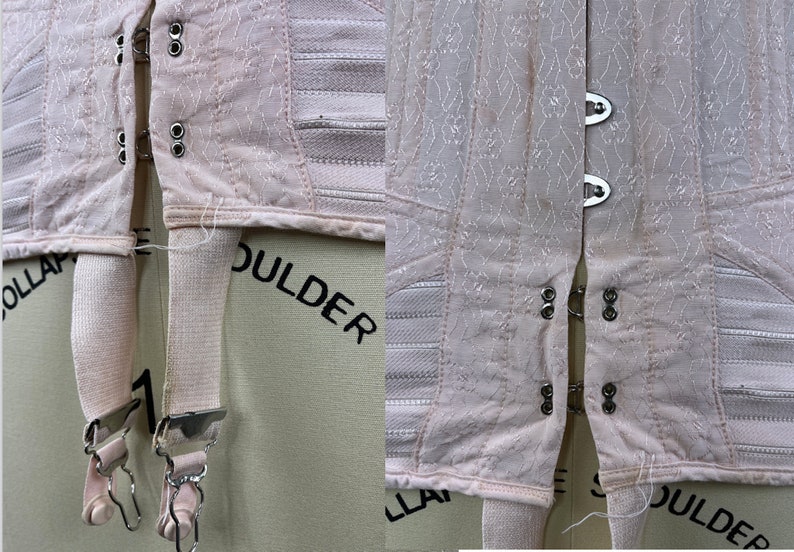 May include: A pair of pink garters with metal clasps and elastic straps. The garters are attached to a pink corset with white elastic bands and metal hooks.