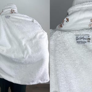 May include: White terrycloth robe with a shawl collar and a medium size label. The collar features a brown and white tropical design. The robe is made of 100% cotton.