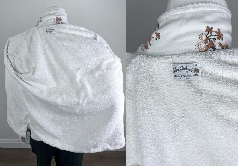 May include: White terrycloth robe with a shawl collar and a medium size label. The collar features a brown and white tropical design. The robe is made of 100% cotton.