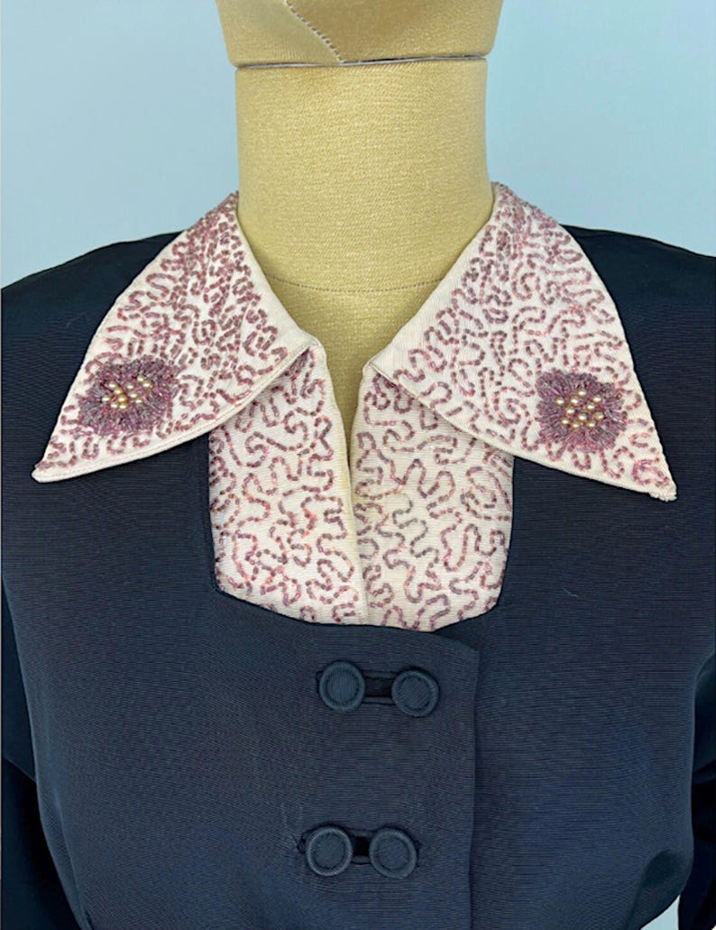 Vintage Black Faille Two Piece Evening Suit Late 1940s Early 1950s Beaded Collar Jacket Nipped Waist Formal Wear Retro Cocktail Attire Pearl Seed Bead Embellished Dusty Rose Details A Line Skirt Set Classic Mid Century Style Double Covered