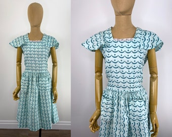 Vintage 1930s/1940s Turquoise Cotton Juniors Dress. Blue Wave & Dot Print. Flutter Cap Sleeve, Gathered Skirt, Patch Pockets and Waist Tie