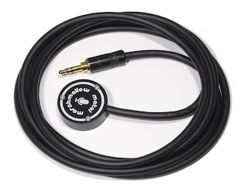 May include: A black audio microphone with a 3.5mm jack and a coiled cable. The microphone has a circular body with the text "marshmallow metal" and a microphone icon. The jack has a gold-colored tip.