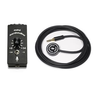 May include: Black audio equipment with the text "metal marshmallow". The equipment includes a black box with a knob and a microphone icon, and a circular component with a microphone icon and a long black cable.