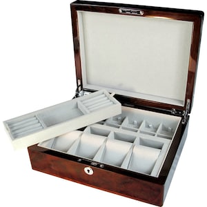 May include: A dark wood jewelry box with a hinged lid and a removable tray. The box has a lock and key and is lined with gray felt. The tray has compartments for rings and other jewelry.