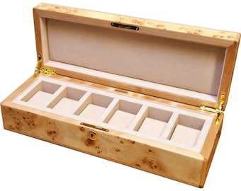 May include: A wooden watch box with a burlwood finish and a gold latch. The box has five compartments for storing watches.