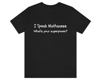 May include: Black t-shirt with white text that reads "I Speak Mathanese. What's your superpower?"