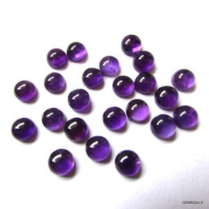 May include: A collection of 20 round, purple amethyst cabochons. The cabochons are smooth and polished, with a slight variation in size and shape.
