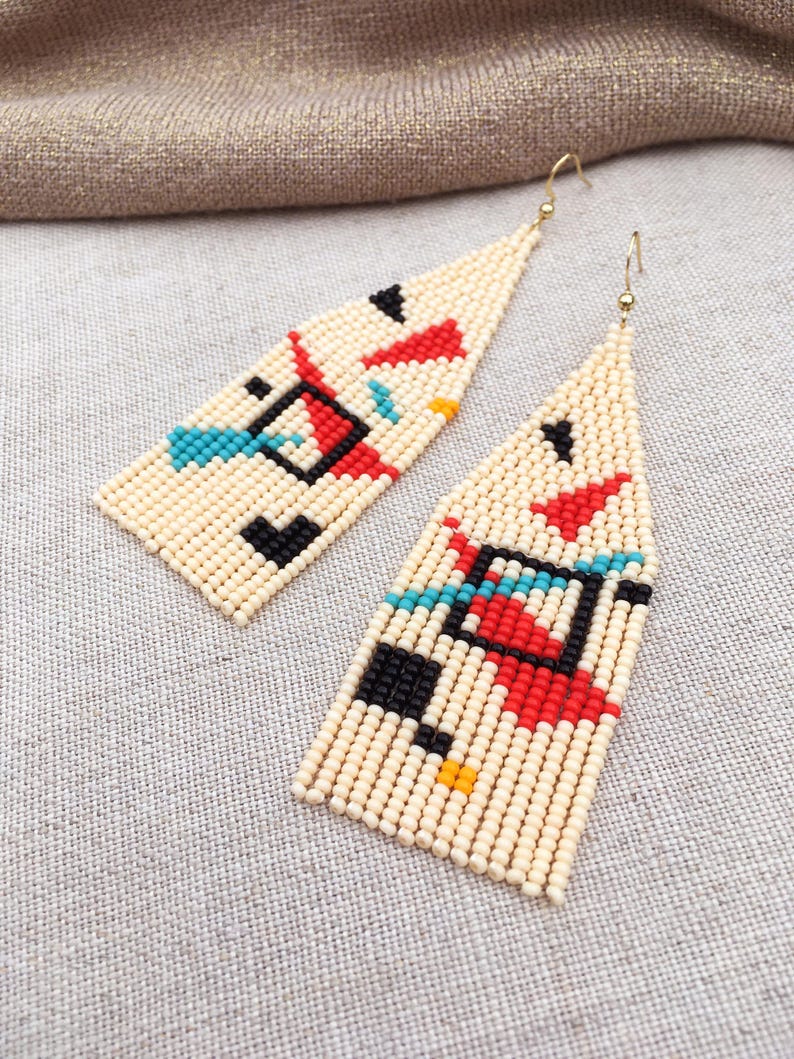 Abstract geometric seed bead earrings inspired by Bauhaus design, featuring ivory, black, red and turquoise color blocks with 18K gold-plated ear hooks.