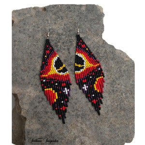 Handwoven black hole beaded earrings with red, gold and black cosmic galaxy design, long fringe seed bead statement jewelry on silver-plated hooks.