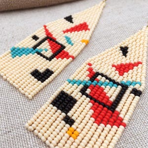 Abstract geometric seed bead earrings inspired by Bauhaus design, featuring ivory, black, red and turquoise color blocks with 18K gold-plated ear hooks.