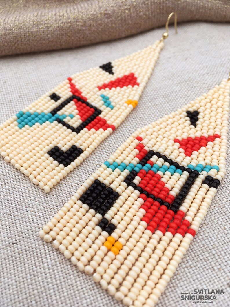 Abstract geometric seed bead earrings inspired by Bauhaus design, featuring ivory, black, red and turquoise color blocks with 18K gold-plated ear hooks.