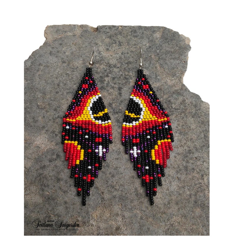 Handwoven black hole beaded earrings with red, gold and black cosmic galaxy design, long fringe seed bead statement jewelry on silver-plated hooks.