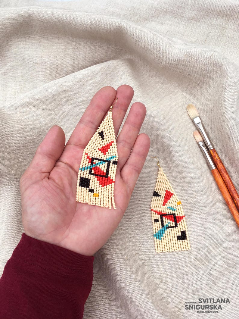 Abstract geometric seed bead earrings inspired by Bauhaus design, featuring ivory, black, red and turquoise color blocks with 18K gold-plated ear hooks.