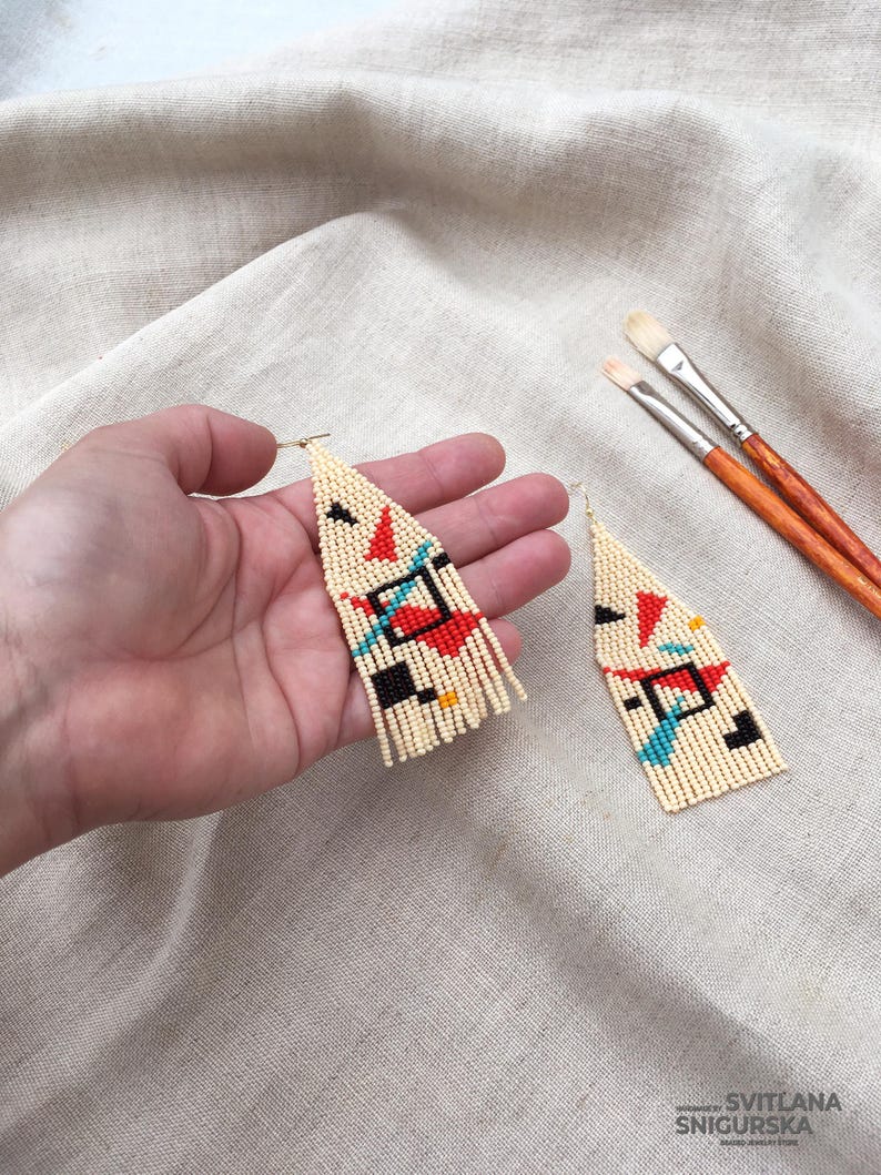 Abstract geometric seed bead earrings inspired by Bauhaus design, featuring ivory, black, red and turquoise color blocks with 18K gold-plated ear hooks.