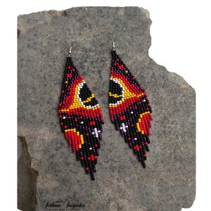 Handwoven black hole beaded earrings with red, gold and black cosmic galaxy design, long fringe seed bead statement jewelry on silver-plated hooks.
