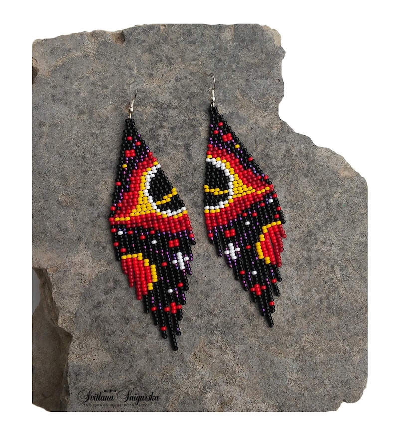 Handwoven black hole beaded earrings with red, gold and black cosmic galaxy design, long fringe seed bead statement jewelry on silver-plated hooks.