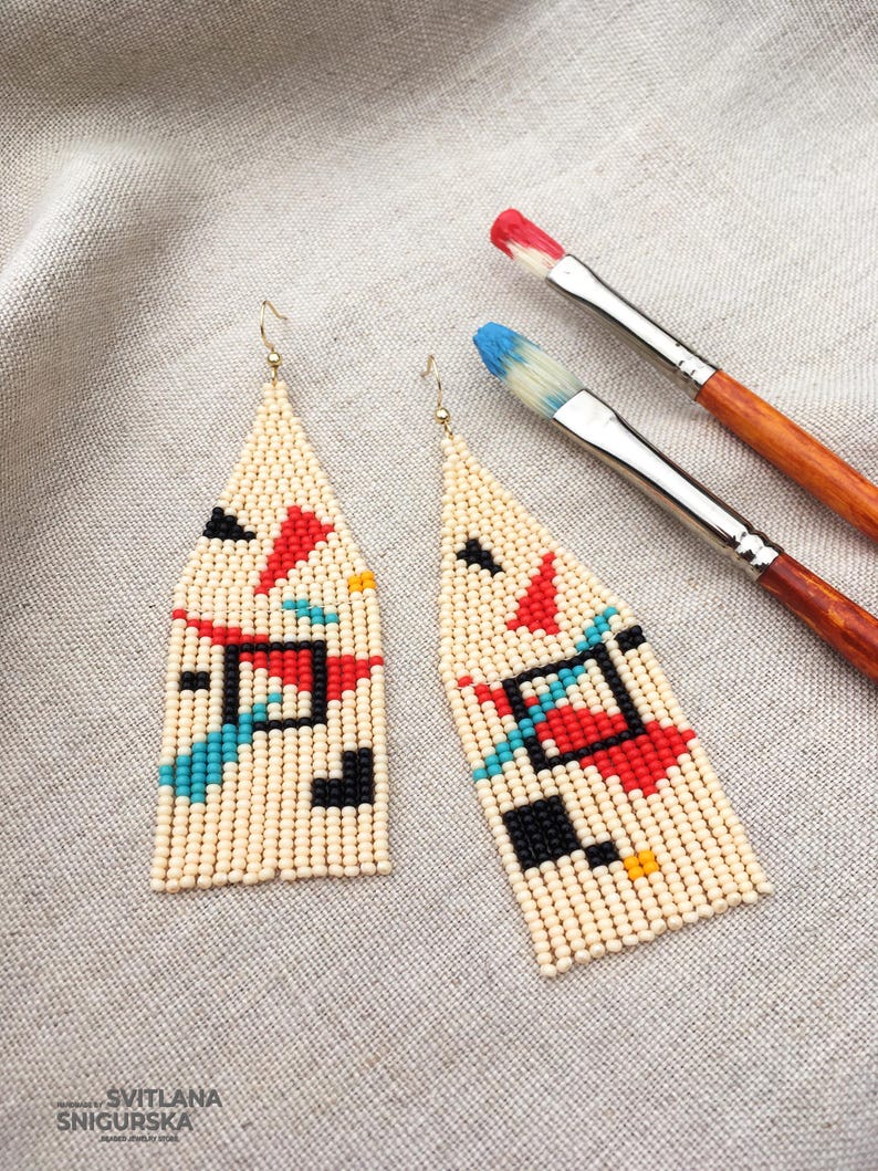 Abstract geometric seed bead earrings inspired by Bauhaus design, featuring ivory, black, red and turquoise color blocks with 18K gold-plated ear hooks.