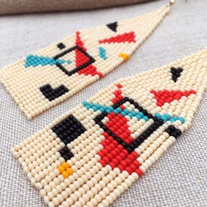 Abstract geometric seed bead earrings inspired by Bauhaus design, featuring ivory, black, red and turquoise color blocks with 18K gold-plated ear hooks.