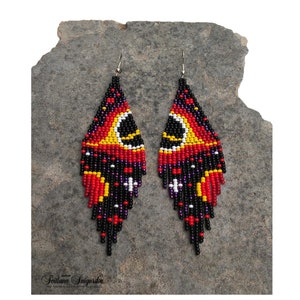 Handwoven black hole beaded earrings with red, gold and black cosmic galaxy design, long fringe seed bead statement jewelry on silver-plated hooks.