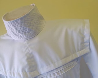 May include: A white collared shirt with a unique textured collar and a single pocket on the left side.