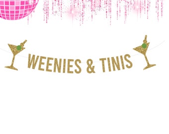 May include: Gold glitter banner with the text "WEENIES & TINIS" and two martini glass silhouettes on either end. The banner is against a white background.