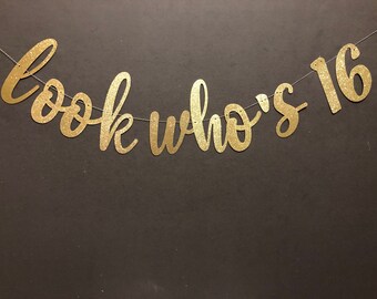 May include: Gold glitter banner with the text "Look who's 16" for a birthday party.