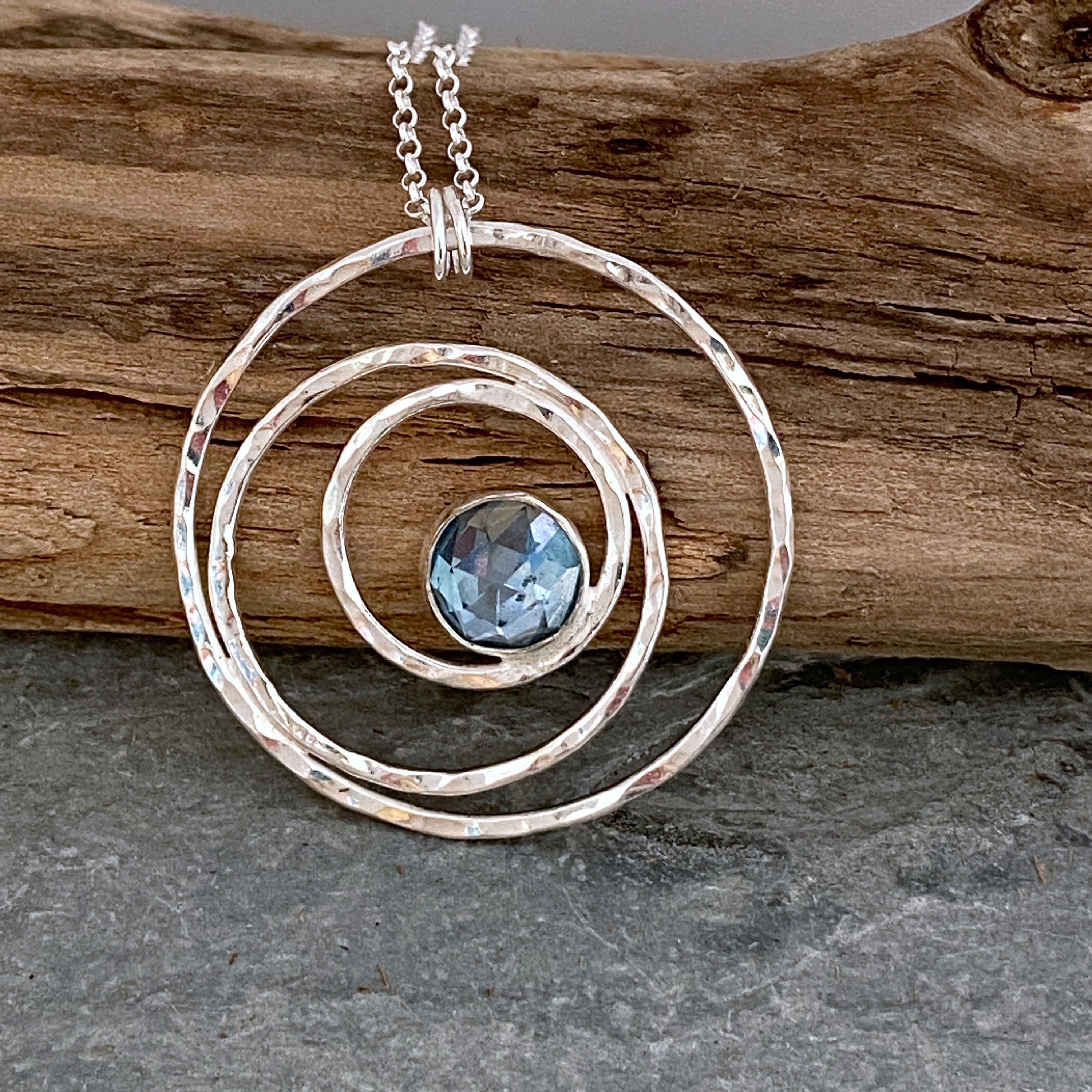Silver Circles Necklace Set With A Blue Topaz Gemstone, Hanging On Sterling Silver Chain