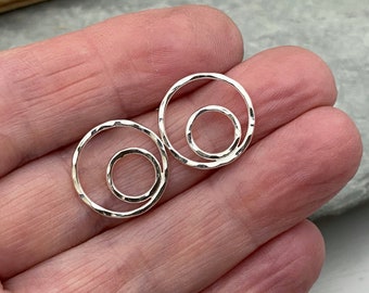 Small round stud earrings with a sparkly hammered silver texture.